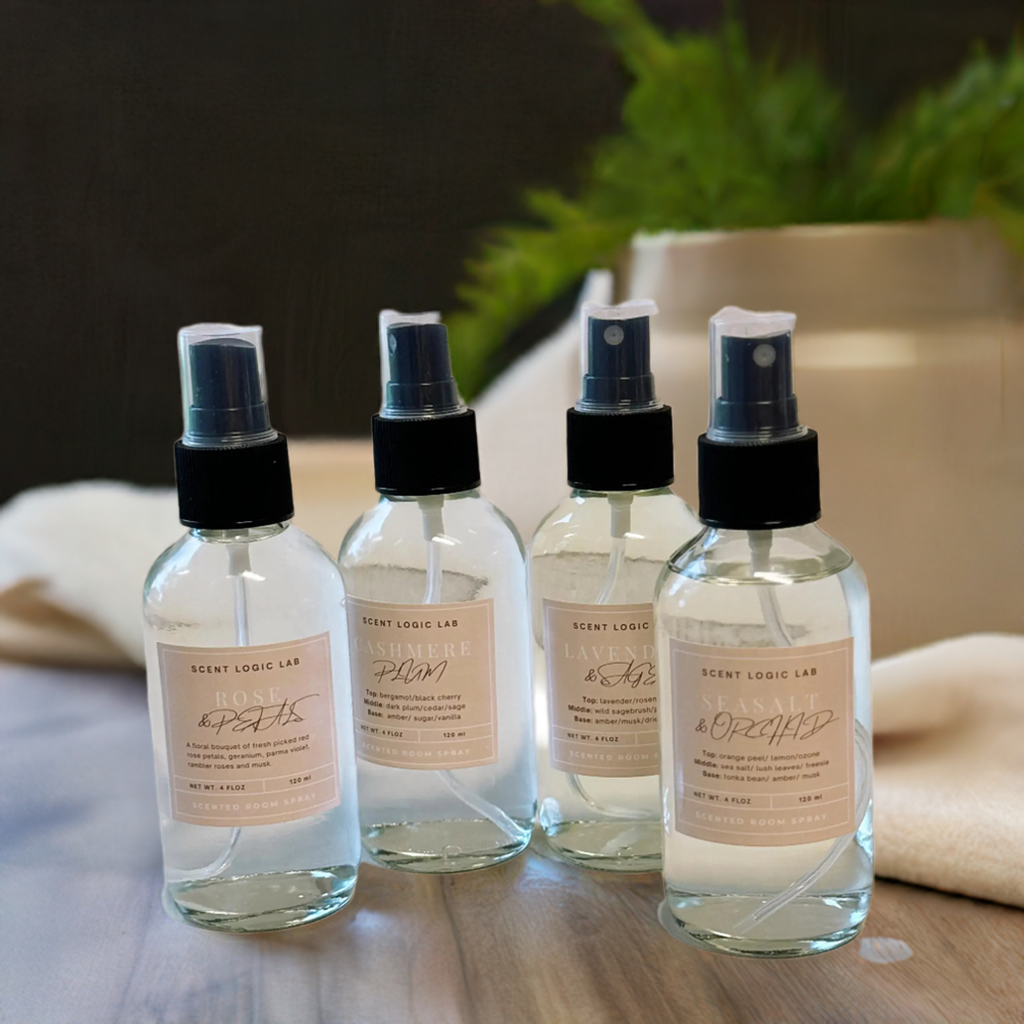 Four spray bottles with labels on a wooden surface with a blurred background
